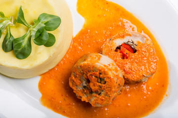 Stuffed chicken roll with red sauce and mashed potatoes
