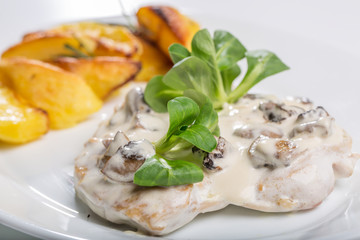 Tasty grilled chicken with mushroom sauce and baked potatoes