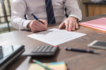Businessman signing a document