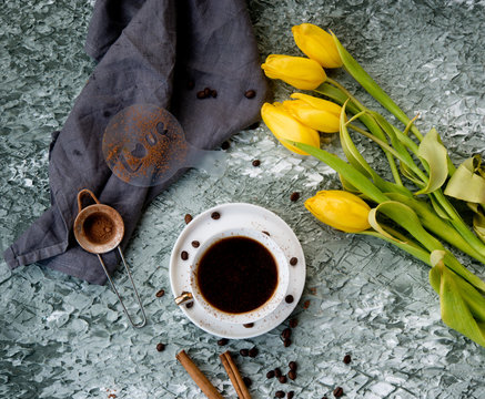 Black coffee on a table with flowers
