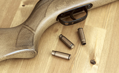 long gun riffle on a table with ammo