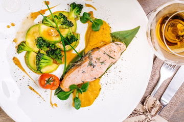 grilled salmon steak on a round white plate