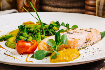 grilled salmon steak on a round white plate