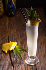 Ping Kolad's cocktail with rum, pineapple juice, coconut syrup with a pineapple piece in a high...