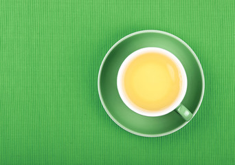 Full cup of green tea close up elevated top view