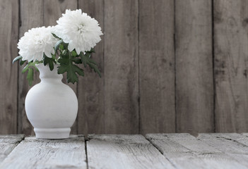 chrysanthemum in vase on wooden table
