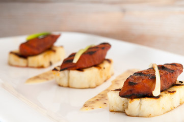 Halloumi cheese and grilled meat starter on white plate