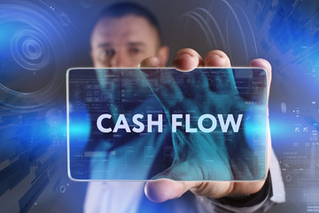 Business, Technology, Internet and network concept. Young businessman working on a virtual screen of the future and sees the inscription: Cash flow