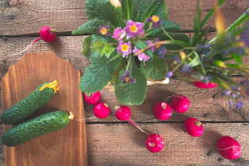 Still life of a cucumber radish on a wooden background.