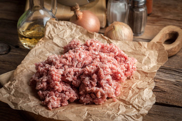 Minced meat on wooden background.