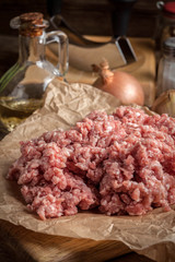 Minced meat on wooden background.