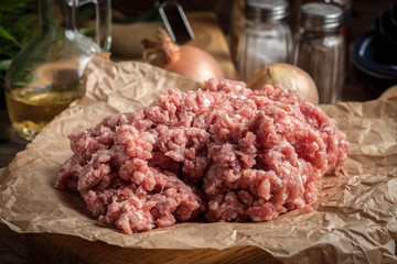 Minced meat on wooden background.