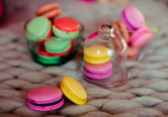 Bowls with macaroons lie on woolen plaid