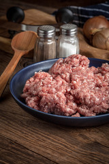 Minced meat on wooden background.