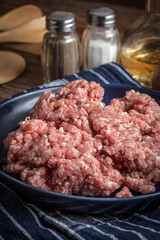 Minced meat on wooden background.