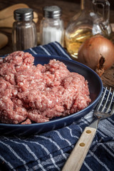 Minced meat on wooden background.