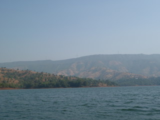 Fototapeta premium view of lake and hill with blue background