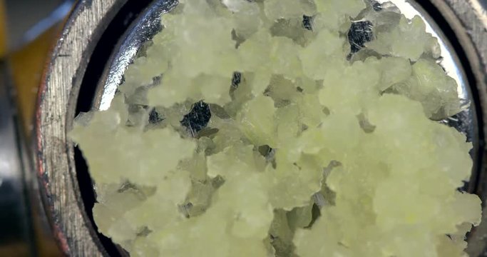 Pressing garlic from kitchen press in slow motion