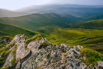 Fototapeta na wymiar Mountain valley during sunrise / sunset. Natural summer landscape. Colorful summer landscape in the Carpathian mountains. Stone surface