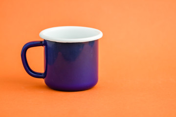 Colorful Enamel Mug on Orange Background
