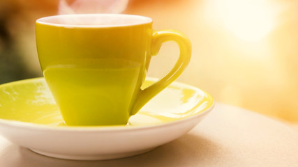 green cup of coffee in the sunlight