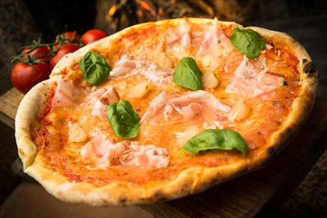 Pizza with bacon, onion, parmigiano, mozzarella, tomato sauce and basil, Italian Food