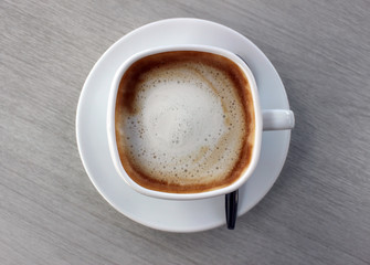 Above view of a single coffee in a square-shaped cup
