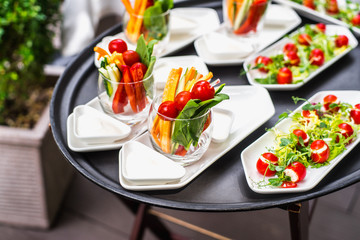 Plates with vegetable mix, food snacks on an event party, wedding, birthday or dinner