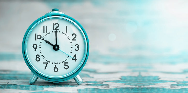 Time concept - website banner of a blue retro alarm clock