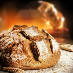 Freshly baked bread in rustic bakery with traditional oven - 143426221