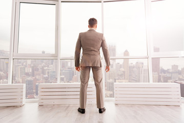 Confident businessman standing in his office