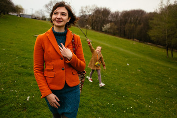 The mother and daughter walking along park