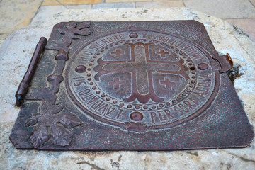 An ancient iron hatch on the well