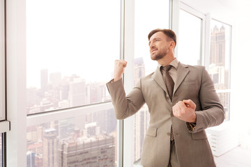 Fototapeta premium Successful businessman standing near office window