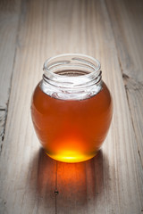 Honey in jar on the old wood