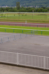 Turnstiles and fences to limit the movement of people across the territory. Part of the racecourse without people and animals. Racecourse of France, the city of Divonne les Bains