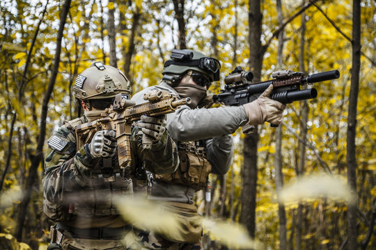 Two United states Marine Corps special operations command Marine Special Operators also known as Marsoc raiders in camouflage uniforms in the forest