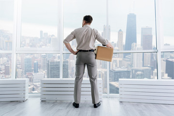 Pleasant businessman standing in the office