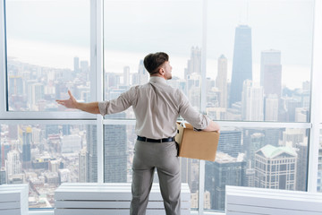 fired businessman felling sad and carrying his belongings