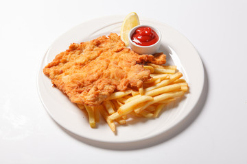 Fried fish and chips on the white plate