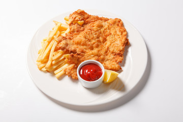Fried fish and chips on the white plate