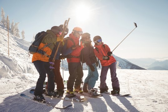 Group of skiers taking selfie on mobile phone
