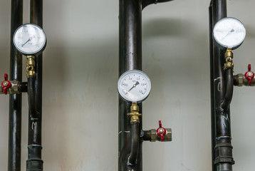 Heating pipes with manometers / The picture was taken in Russia. Heating systems for apartment...