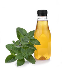 Bottle of honey and Fresh mint leaves  isolated on white