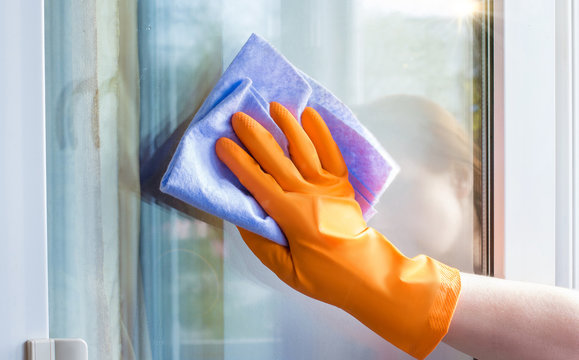 A worker wipes the window with .