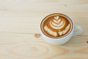 Hot art Latte Coffee in a cup on wooden table