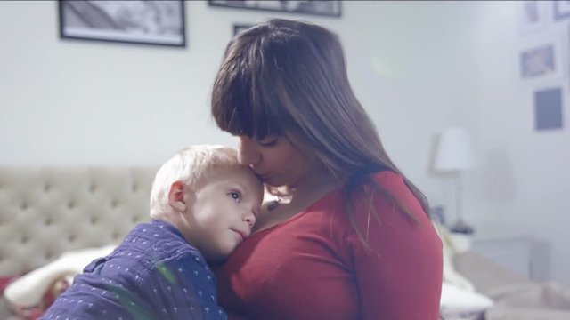 Cute little boy is cuddle to mum. FULL HD. slow motion