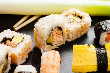 Slate tray of assorted sushi