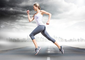 Fototapeta na wymiar Female runner going across road with skyline and storm