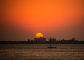 Fototapeta na wymiar Sunset at sea, sailboat beach sun